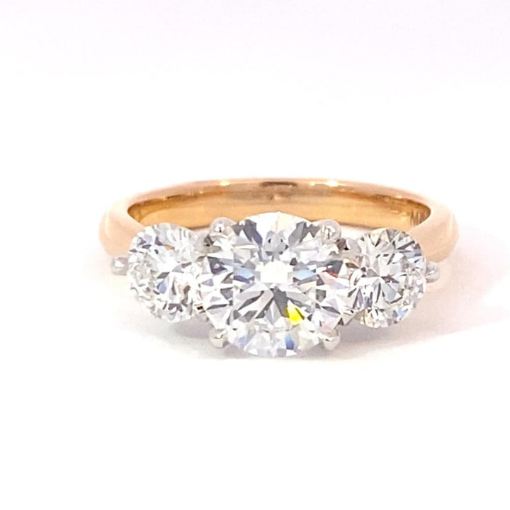 Trilogy round brilliant cut diamond ring on rose gold band
