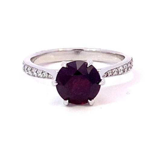 Round brilliant cut ruby ring with diamond band