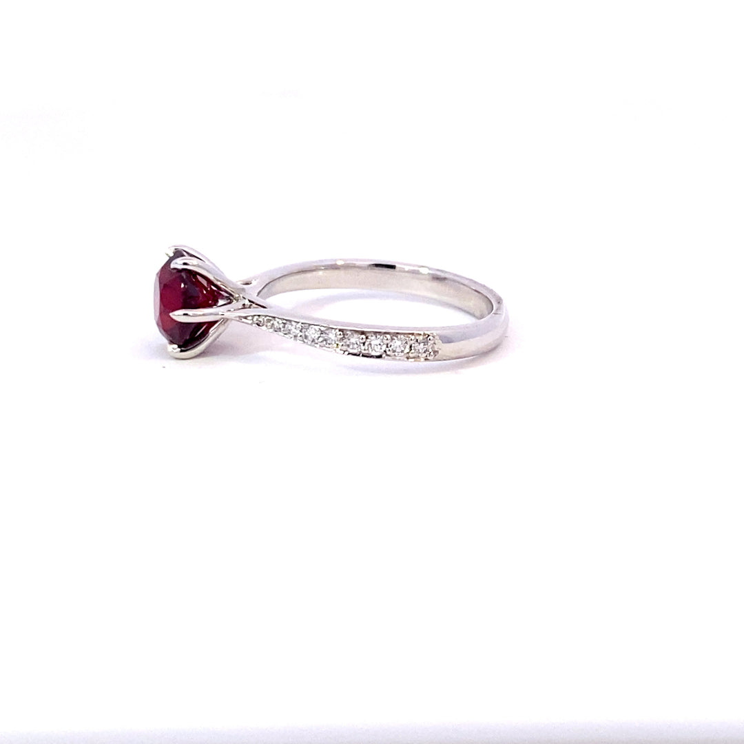 Round brilliant cut ruby ring with diamond band