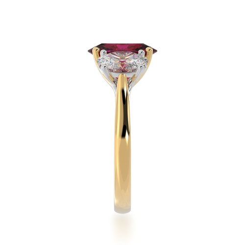 Trilogy oval cut ruby and diamond ring on yellow gold band view from side.