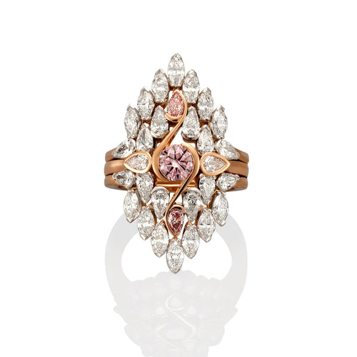 Rose gold multi piece ring with 28 white diamonds and 3 pink sapphires. The ring is photographed on a high gloss white background with a ring reflection showing in the foreground