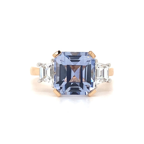 Front view of the Trilogy square cut blue sapphire engagement ring with diamonds on rose gold band by Mondial by Nadia.