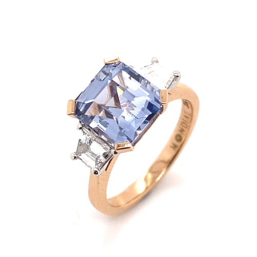 Side top view of the Trilogy square cut blue sapphire engagement ring with diamonds on rose gold band by Mondial by Nadia.