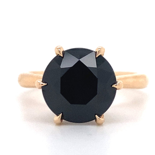 Round brilliant cut black sapphire solitaire ring on rose gold band