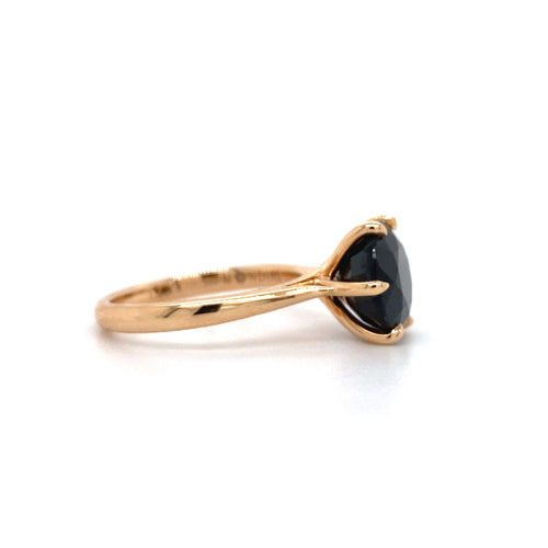 Round brilliant cut black sapphire solitaire ring on rose gold band