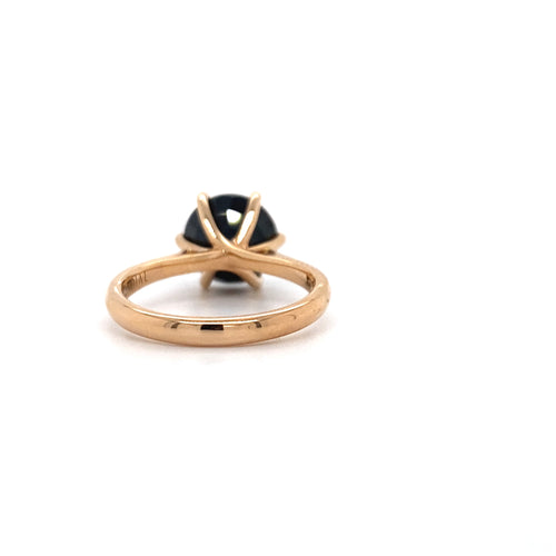 Round brilliant cut black sapphire solitaire ring on rose gold band