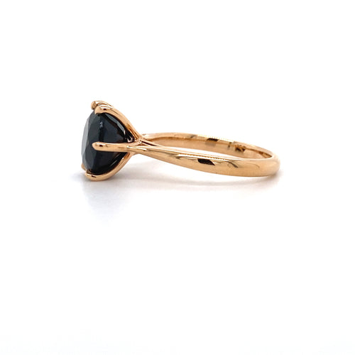 Round brilliant cut black sapphire solitaire ring on rose gold band