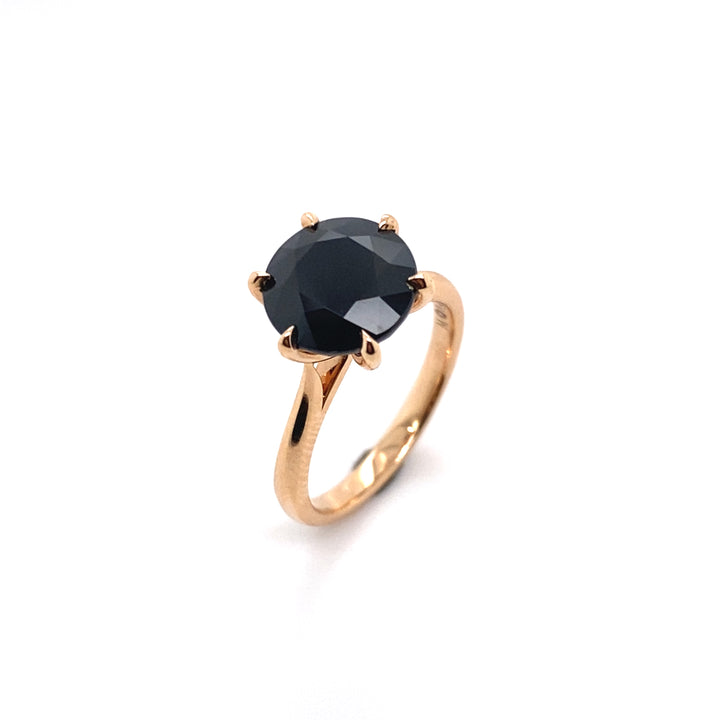 Round brilliant cut black sapphire solitaire ring on rose gold band