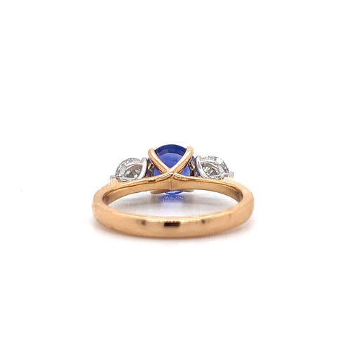 View from the back of the Trilogy round brilliant cut blue sapphire engagement ring with diamonds on rose gold band by Mondial by Nadia.