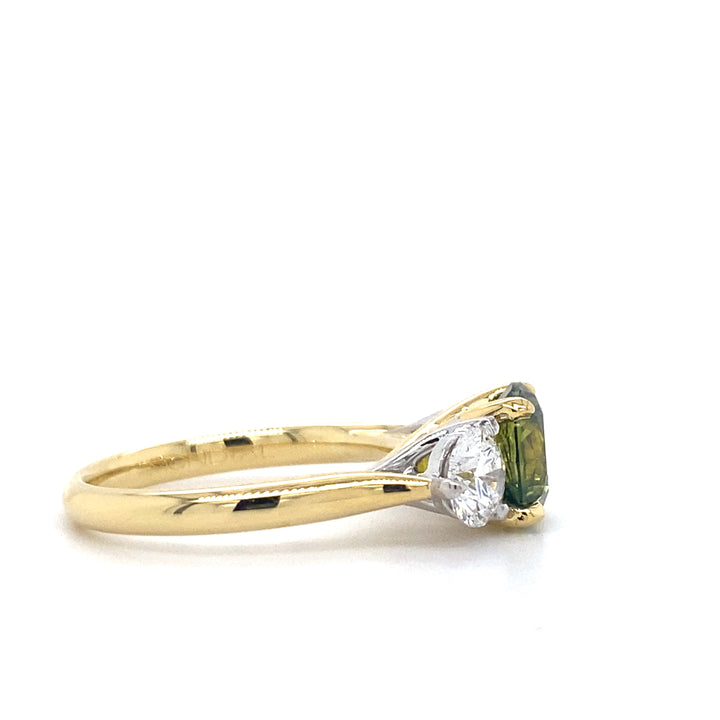 Trilogy round brilliant cut green parti sapphire and diamond ring on yellow gold band