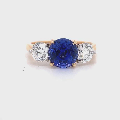 Video of the Trilogy round brilliant cut blue sapphire engagement ring with diamonds on rose gold band by Mondial by Nadia.