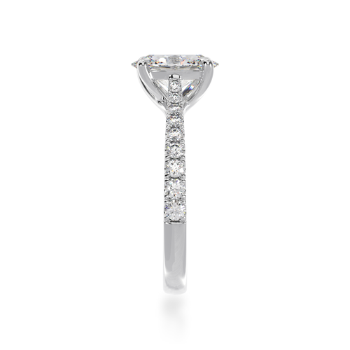 Oval cut diamond solitaire with a white gold diamond set band from side standing view.