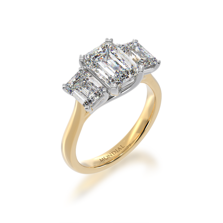 Trilogy emerald cut diamond ring on yellow gold band view from angle 