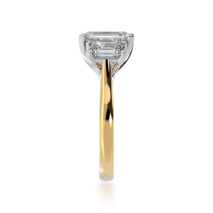 Trilogy emerald cut diamond ring on yellow gold band view from side