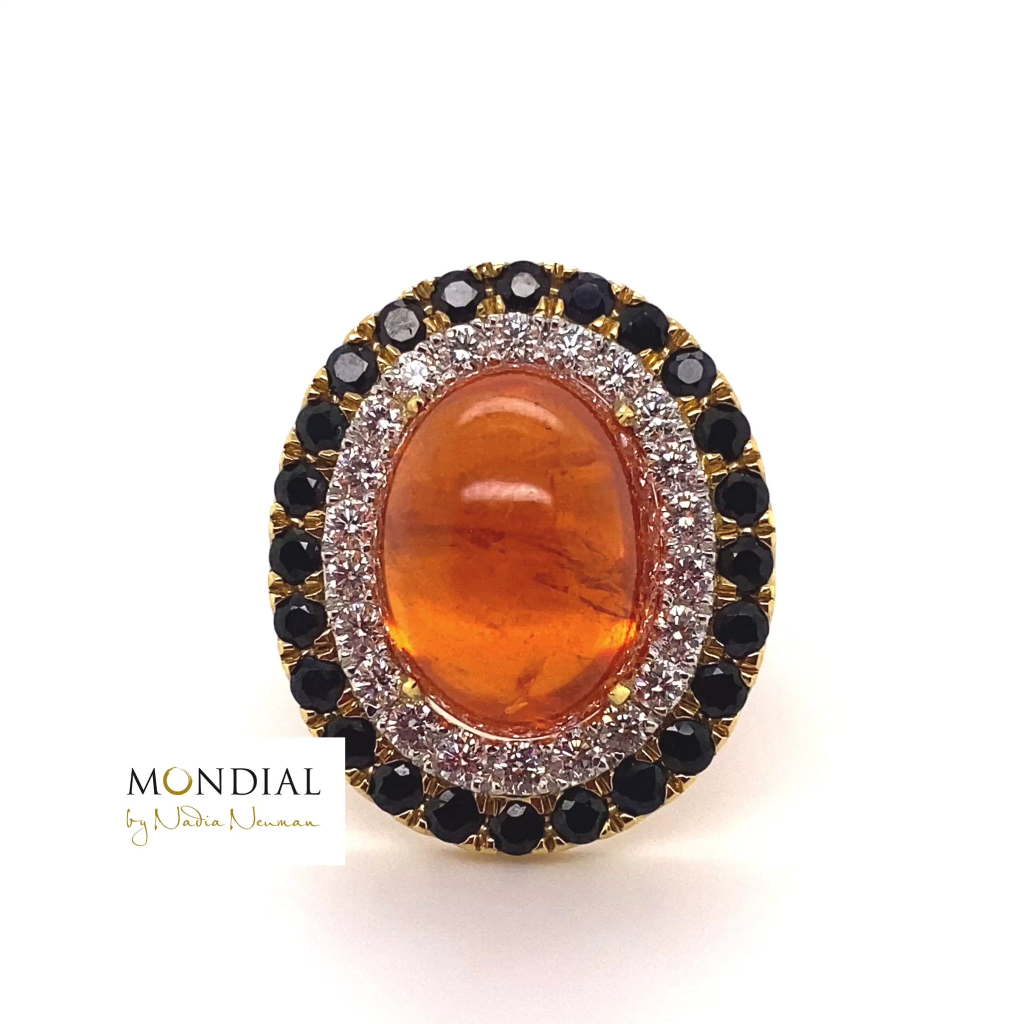 Video of the Mondial by Nadia oval cabochon Spessartite garnet, sapphire and diamond halo engagement ring on yellow gold band.