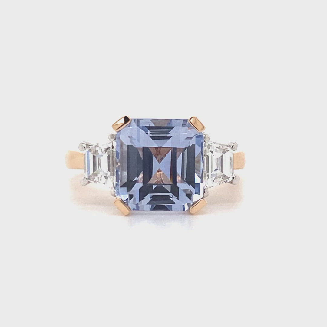 Video of the Trilogy square cut blue sapphire engagement ring with diamonds on rose gold band by Mondial by Nadia.